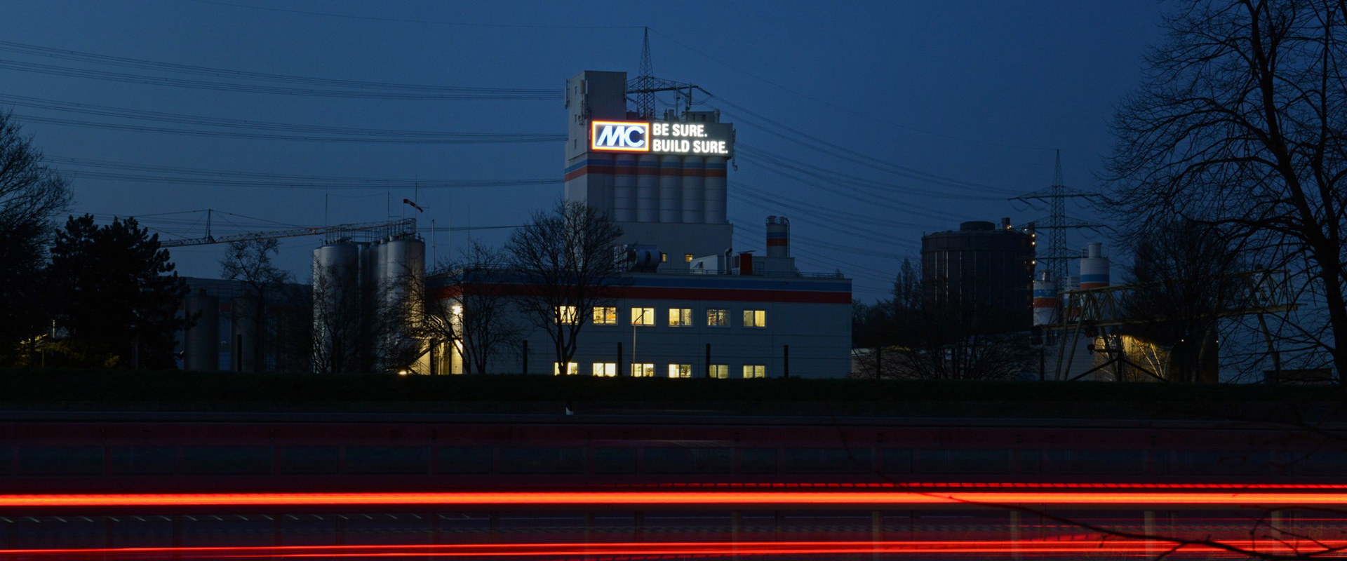 Giant logo on façade of MC-Bauchemie powder tower in Bottrop