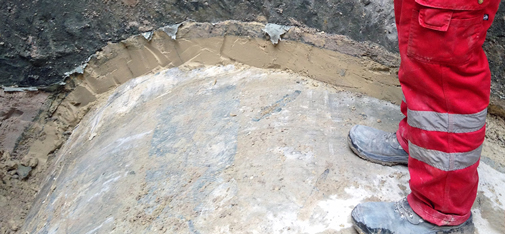 View of the backfill grout as applied under pressure between the tubbing segment and the rock in a haulage shaft.